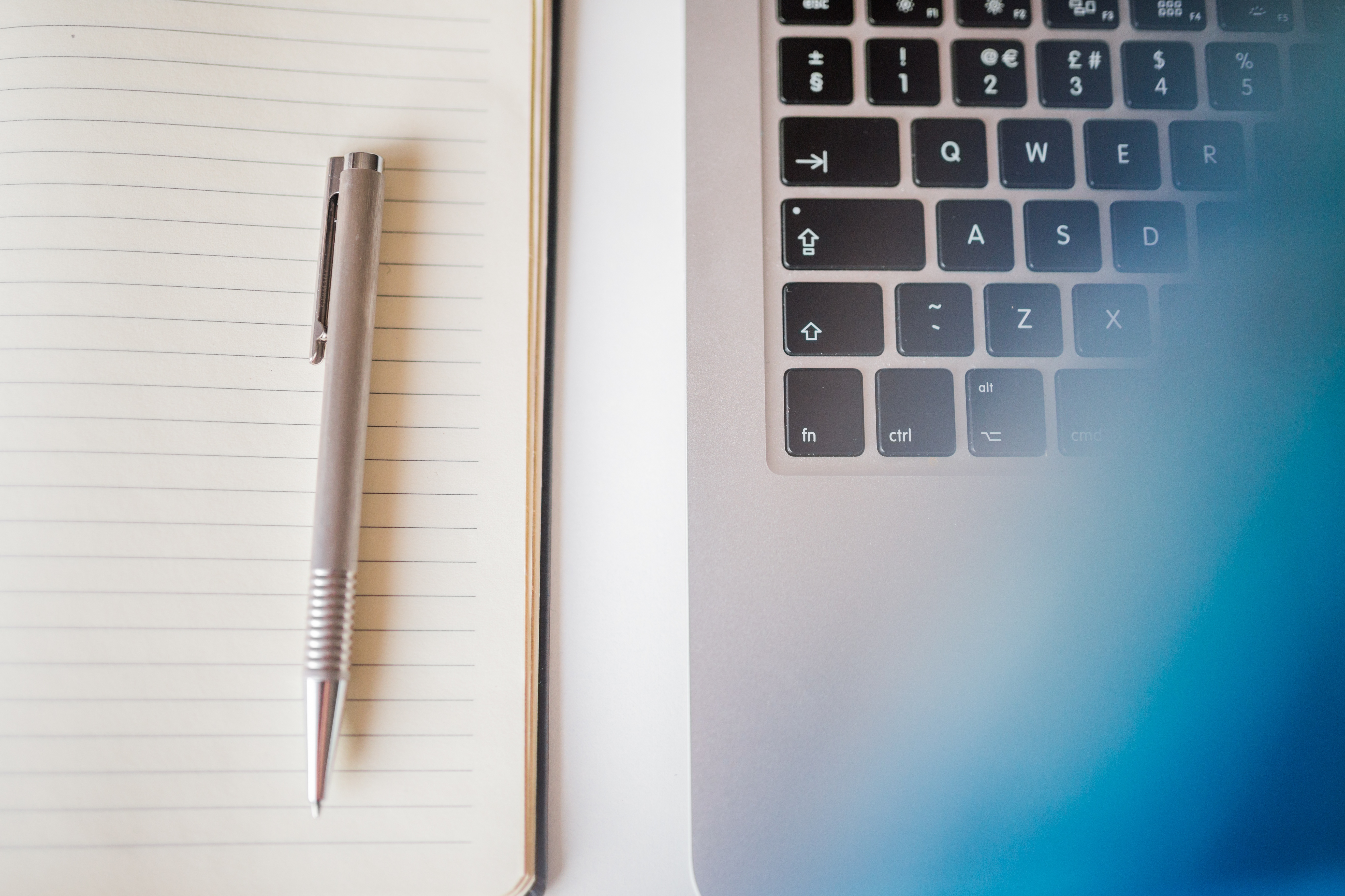 pen-and-notebook-next-to-laptop pen-and-notebook-next-to-laptop