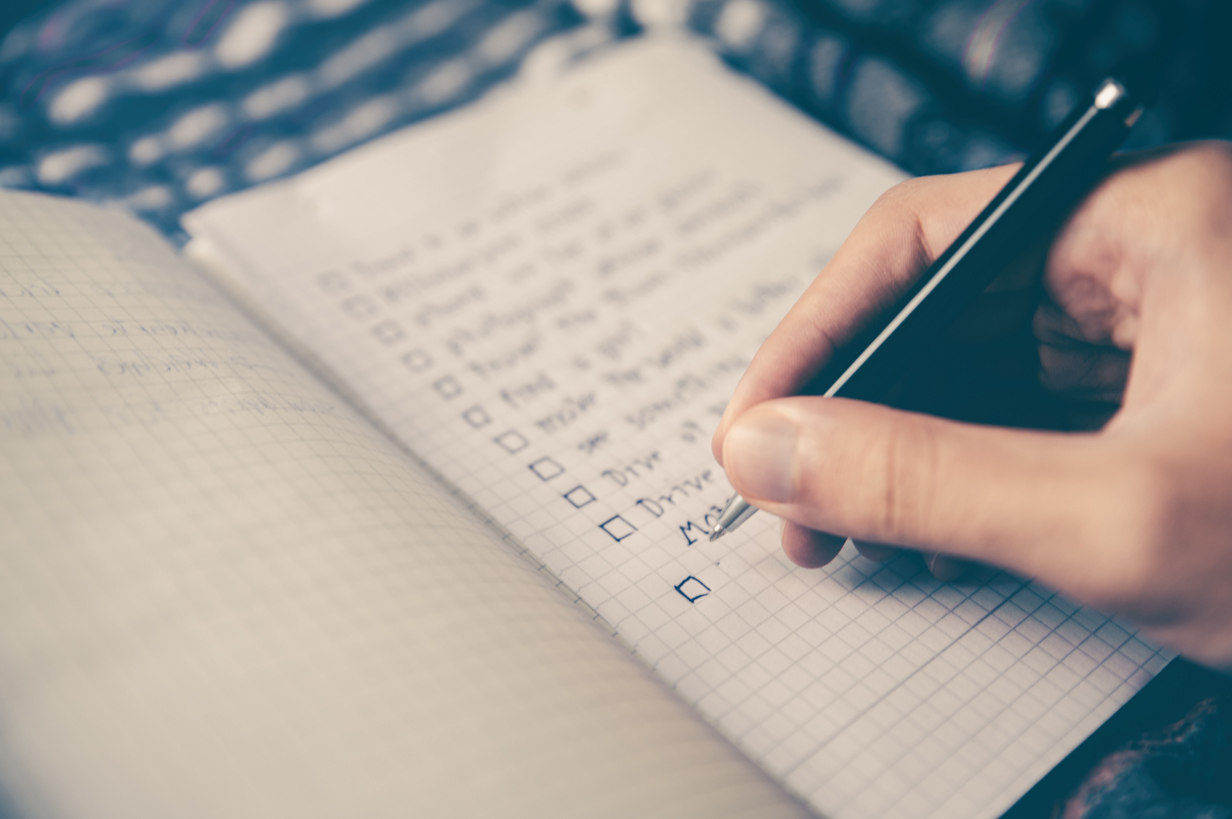 Person writing list person-writing-list-on-paper