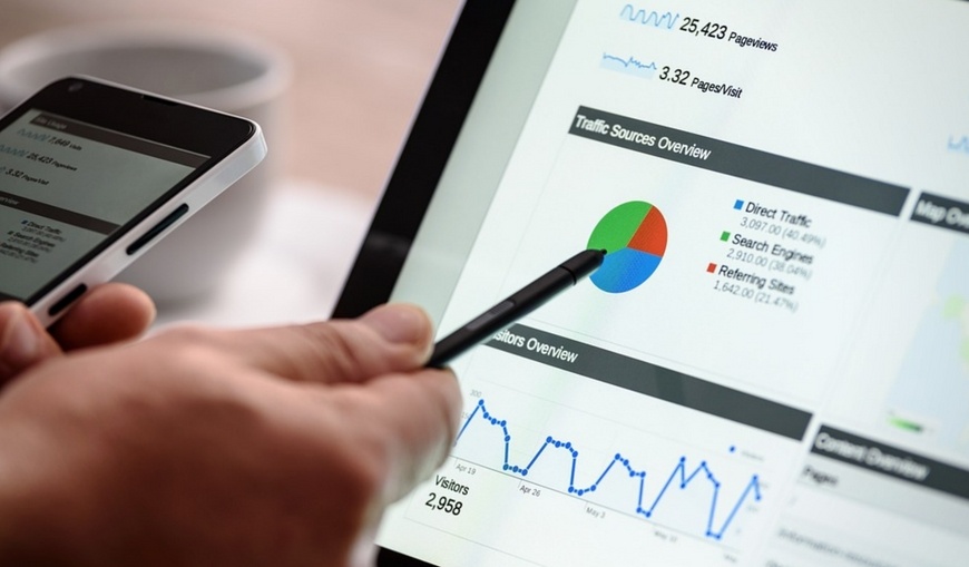 Marketer-analyzing-traffic-market-research-on-laptop-and-smartphone Marketer-analyzing-traffic-market-research-on-laptop-and-smartphone